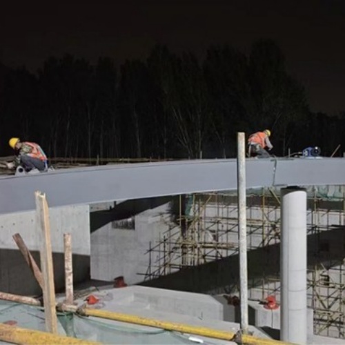 Steel bridge girders being installed at night