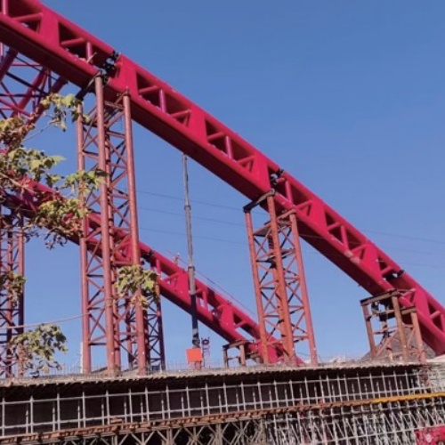 Red steel truss gantry under construction