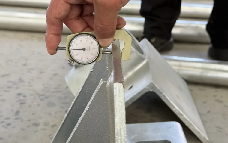 Quality inspector checking manufactured steel components