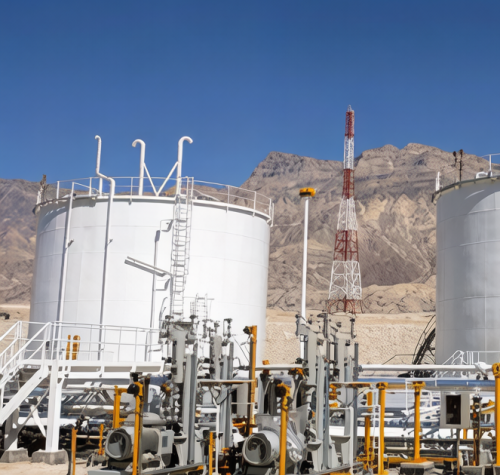 Oil and gas storage tanks with steel access platforms and pipework