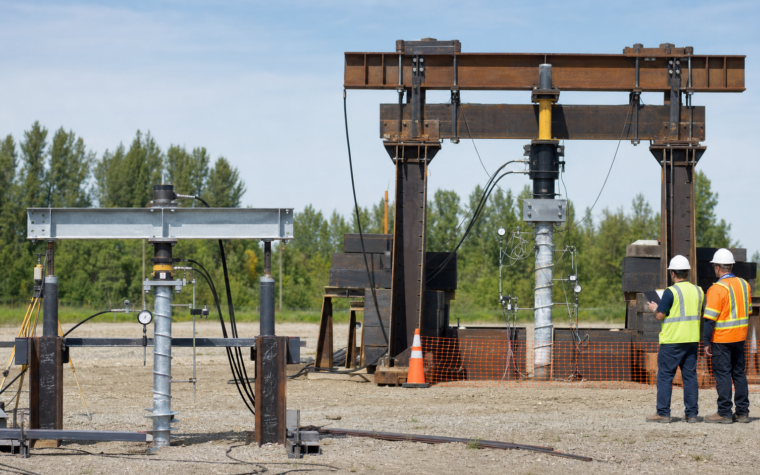 Editorial concept showing a compact verification station and a separate, larger investigation station for helical screw piles.
